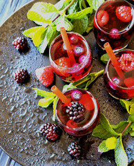 berry juice in a glass with berries, selective focus