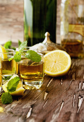 Glass of whiskey with mint and lemon