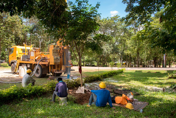 Ground water hole drilling machine installed on the old truck in Thailand. Worker waiting and keeping an eye on Ground water well drilling.
