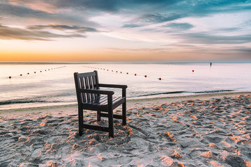 Chair left on the beach at sunrise