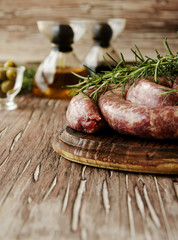 raw beef sausages on a cast-iron pan,  selective focus