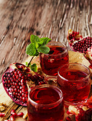 Fresh pomegranates and juice, selective focus