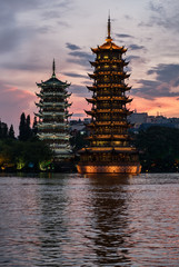 Sun and moon pagodas at sunset in Guilin city, China.