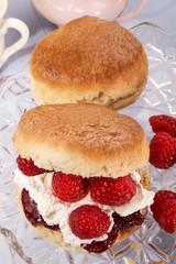 english scone with whipped cream and fresh raspberry