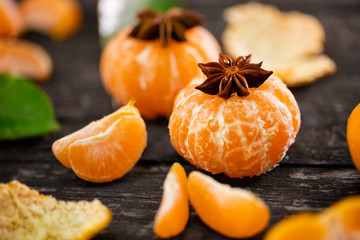 tangerines with anise star on wooden background.