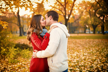 Couple in love kissing in park autumn