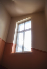 Fototapeta na wymiar Soft light beaming through a window into a staircase