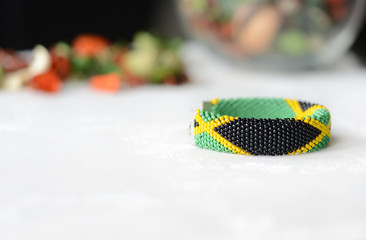 Fototapeta na wymiar Jamaican flag bead crochet bracelet close up