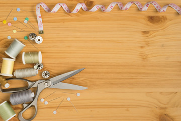 top view of tools for handicraft sewing on wood texture, space for input text