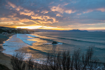 Surfers in Sopelana beach at dusk