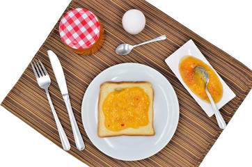 Breakfast with jam egg and bread close up