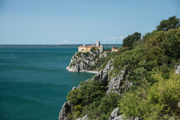 Duino Castle, a fortification of the 14th century in the Gulf of Trieste, seen from a panoramic footpath called Rilke trail. Northeastern Italy, Europe.