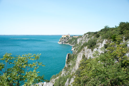 Duino Castle, a fortification of the 14th century in the Gulf of Trieste, seen from a panoramic footpath called Rilke trail. Northeastern Italy, Europe.