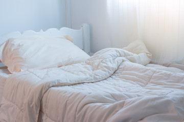 Fototapeta na wymiar White themed bed sheets bedroom interior.