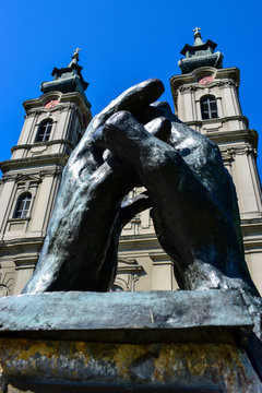 statues of a hands set up for praying in front of the Cathedral of St. Theresa of Avila, 30th of Jun 2017, Subotica, Serbia