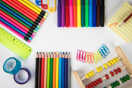 Rainbow of colors with school pencils school supplies and school accessories