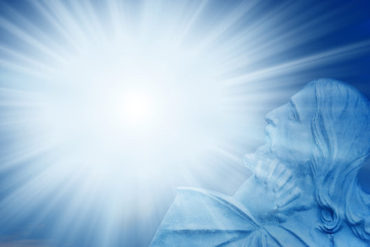 Jesus Christ with divine Light over blue background with rays of light and copy space 
