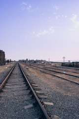 Naklejka premium Railway station against beautiful sky at sunset.