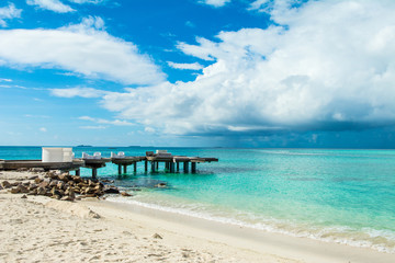 Fototapeta na wymiar Chill lounge zone on the sandy beach, Maldives island