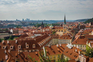 Fototapeta na wymiar Church of Saint Thomas and old buildings with red roofs in Prague, Czech Republic