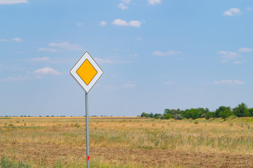 Road sign main road on the sidelines of dry prairie