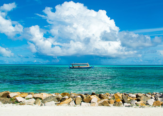 Wooden Maldivian traditional dhoni boat at sunny day on the turquoise Indian ocean water, Maldives