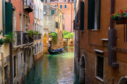 colorful Venetian Canal with gondola, Venice Italy