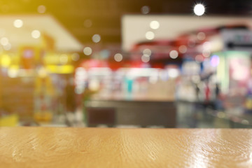 Wooden floor on Blurred shopping mall or indistinct department store.