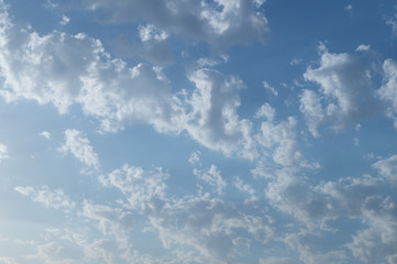 Bright small cumulus clouds on the blue sky