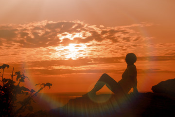 A woman enjoys the sunset and relaxes