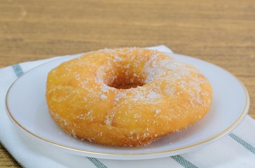 Glazed Donut with Sugar on White Dish