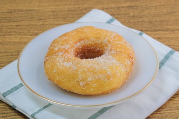 Glazed Donut with Sugar on White Dish