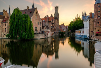 Fototapeta na wymiar Bruges (Brugge) cityscape with water canal at sunset