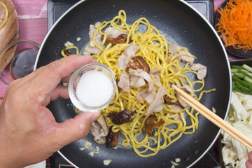 Chef put sugar for cooking Yakisoba noodle