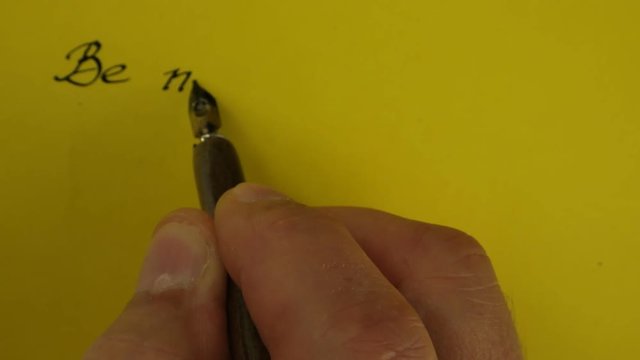 The writing with ink and a fountain pen short sentence about positive emotion  on  a yellow paper