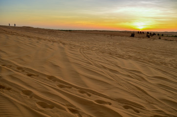 Fototapeta na wymiar Beautiful white sand dunes ripples and footprint in sunrise morning, White Sand Dune at Muine, Vietnam. Vacation concept background.