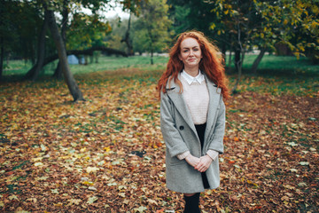 redhead girl in autumn park