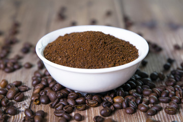 bowl with ground coffee and coffee beans
