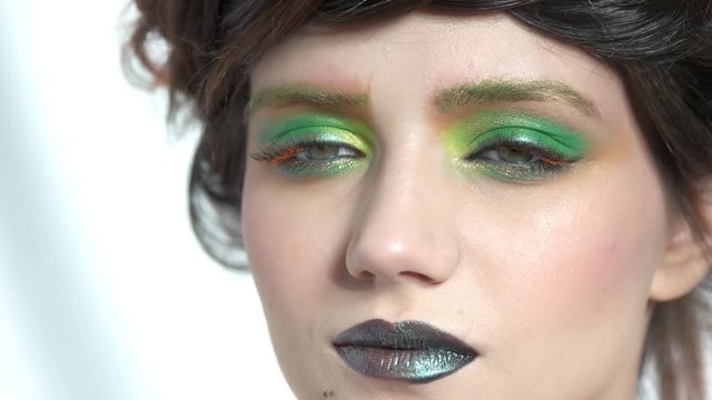Visagist using lip brush. Female face, beautiful makeup.