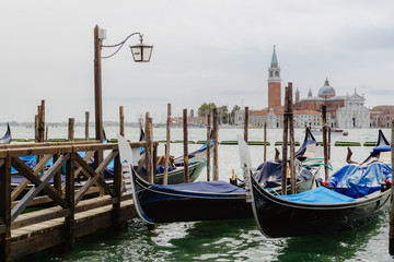 Fototapeta na wymiar Traditional gondolas and San Giorgio Maggiore, Venice Italy
