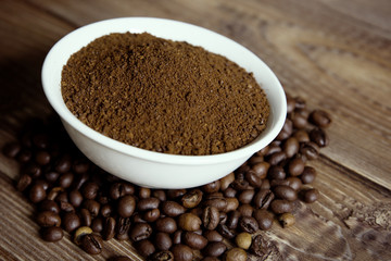 bowl with ground coffee and coffee beans