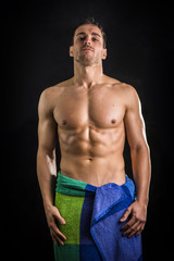 Portrait of naked handsome young man with languishing look with a towel around his waist