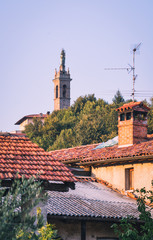 View of old bell tower over ancient italian rural houses