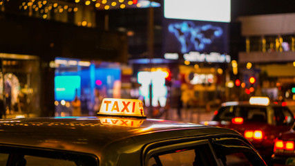 Taxi sign at night blur view in pub and bar nightlife area drunk don't drive