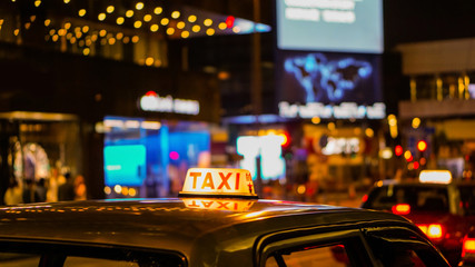 Taxi sign at night blur view in pub and bar nightlife area drunk don't drive