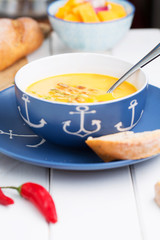 Creamy pumpkin soup on the table, selective focus, vertical
