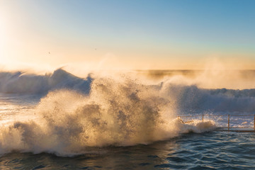 Wave hitting the side of Bronte rock pool.