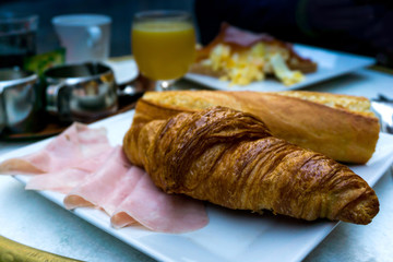 Breakfast with coffee and croissants on table