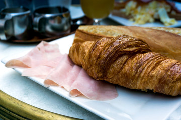 Breakfast with coffee and croissants on table