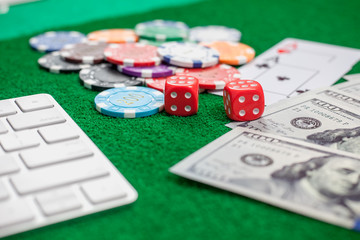 dice poker chips and banknotes on table in casino